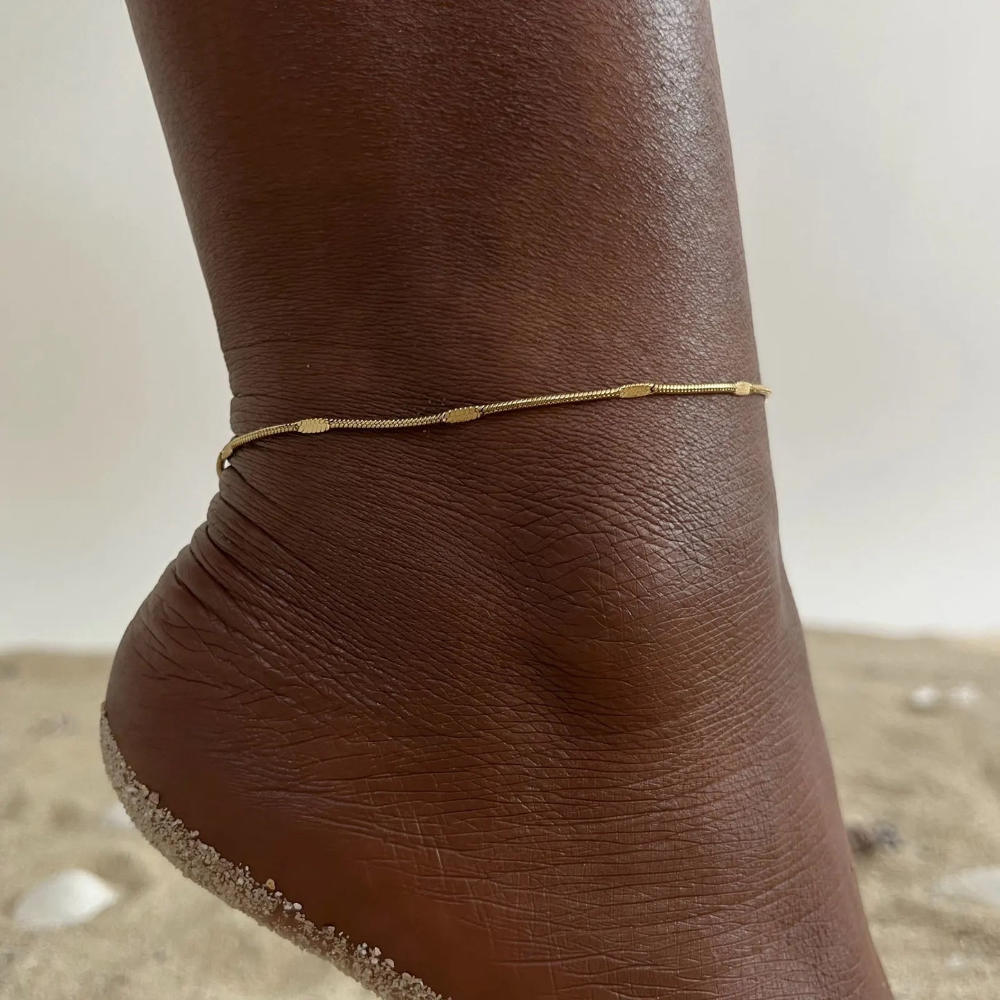 Bracelet de cheville délicat pour femme, style serpent aplati, en acier inoxydable doré, minimaliste, idéal pour la plage ou les vacances.